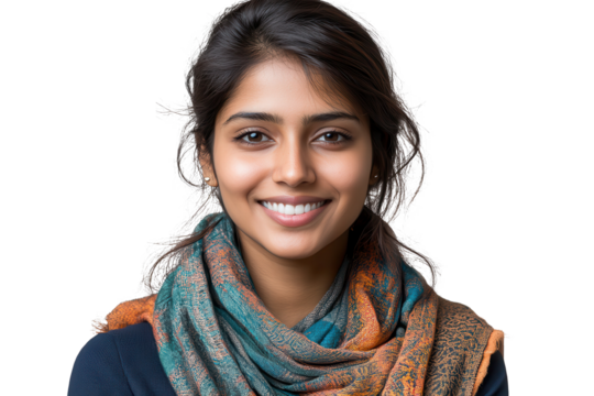Indian woman dressed casually with a colorful scarf smiling confidently in a relaxed indoor setting during daylight hours