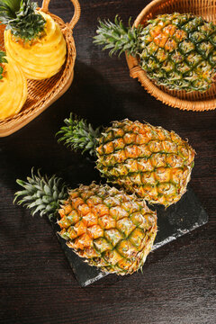 Fresh Tropical Pineapples in Wicker Baskets Display on Rustic Wood Background