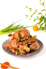 Spicy Stewed Oxtail Dish with Fresh Herbs and Vegetables on Traditional Plate