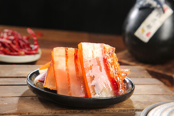 Artisanal Wood-Smoked Bacon Slices on Rustic Plate - Traditional Cured Meat Preparation