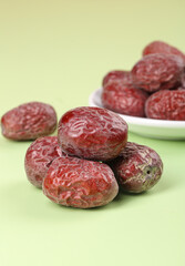 Fresh Xinjiang Jujube Dates - Traditional Chinese Dried Fruit on Green Background