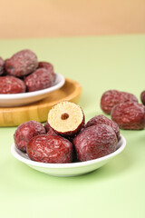 Ruoqiang Red Jujube Dates from Xinjiang China in White Bowls with Cross Section