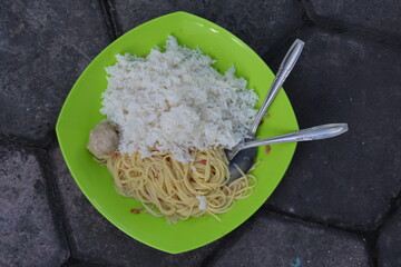 Plate of White Rice and Noodles with Meatball on Green Plate