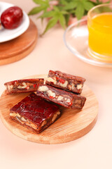 Xinjiang Date Nut Bars with Orange Juice - Traditional Vegetarian Snack on Wooden Plate