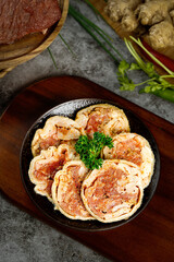 Fresh Mongolian Lamb Buns in Cast Iron Skillet - Traditional Asian Steamed Dumplings with Herbs