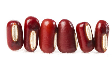 Red kidney beans halved showing interior on white background - healthy vegan protein staple food ingredient