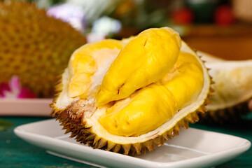 Fresh Durian Fruit with Golden Yellow Flesh Displayed on White Plate