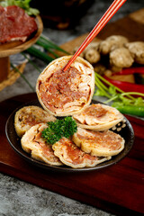 Mongolian Lamb Belly Bun Slices with Chopsticks - Traditional Asian Street Food Meal