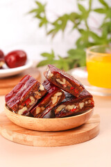 Fresh Xinjiang Jujube and Walnut Pie Slices - Traditional Chinese Sweet Confection on Wooden Plate