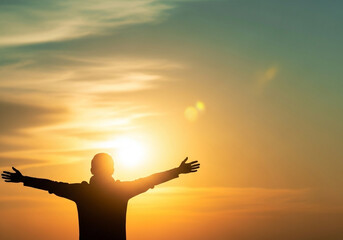 Radiant sky scene of a backlit silhouette with open arms and the sun behind its shoulders, expressing positivity and gratitude for wellness inspiration