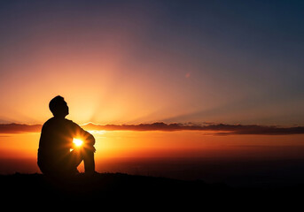 Symbolic gratitude and hope concept of a silhouette holding the glowing sun near its chest, a motivational visual for wellness or lifestyle branding