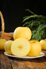 Fresh Golden Yantai Apples with Creamy Flesh on Rustic Wooden Table