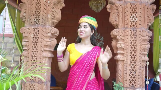 Young indian woman wearing colorful rajasthani turban and pink saree having fun. Culture of india. Rajasthan People. Toursit and Tourism
