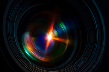 Obraz premium Colorful close-up of a camera lens reflecting light flares, showcasing optical glass layers, vibrant spectrum, and professional photography design.