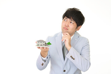 家の模型を持つ男性