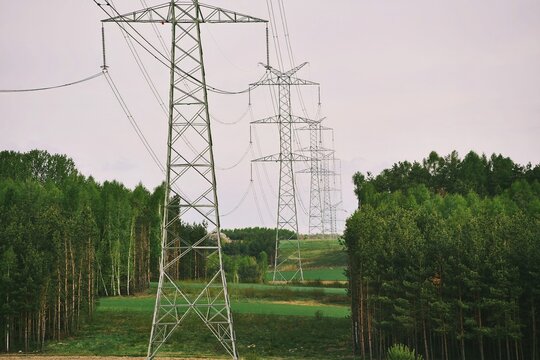 Electric towers in green agricultural landscape