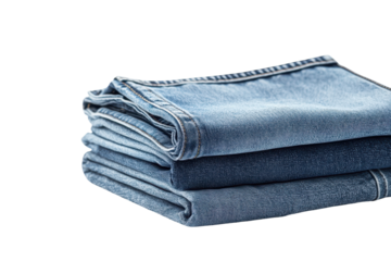 Folded jeans neatly stacked on a white surface showcasing different shades of denim fabric