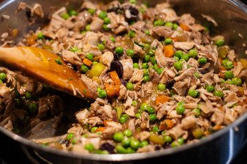 Turkey pot pie filling stirred with peas, carrots, and celery