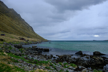 Rocky beach, blue sea with rocky mountain