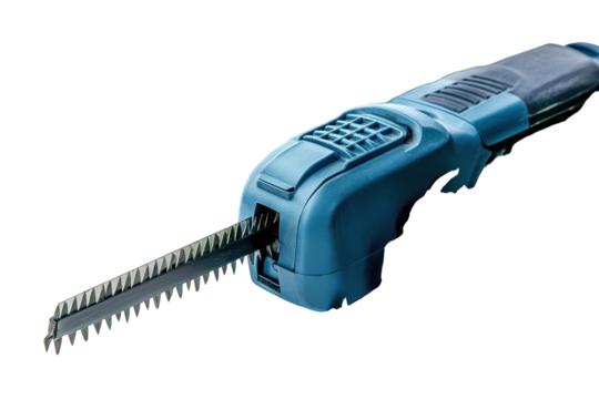 Electric hedge trimmer with sharp blades surrounded by freshly cut green foliage positioned on a clean surface