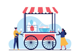 Enjoying sweet fluffy treats from a colorful confectionery cart on a sunny day