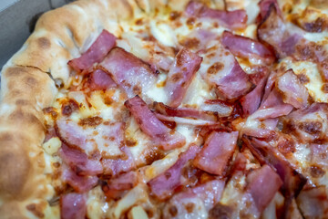Close up of bacon and cheese pizza