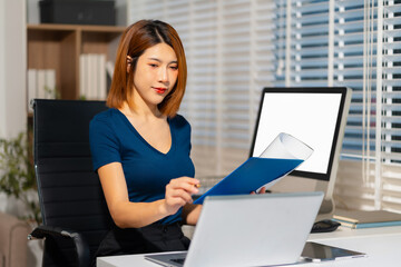 lifestyle of office workers Woman calculating expenses and using laptop. Home office. Work place....