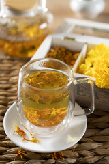 Enjoying a calming marigold tea in a cozy setting with vibrant flowers and natural textures