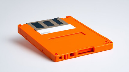 Bright orange 3.5-inch floppy disk isolated on a clean white background, retro data storage device, vintage computer technology