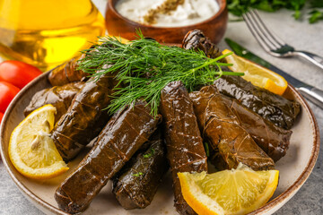 Delicious Turkish dish, stuffed grape leaves, on a stone table
