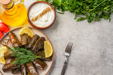 Delicious Turkish dish, stuffed grape leaves, on a stone table
