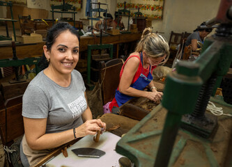 Cuban women hand rolling premium cigars with traditional techniques, revealing artisanal...