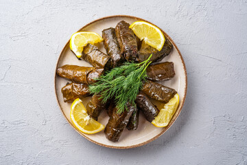 Delicious Turkish dish, stuffed grape leaves, on a stone table