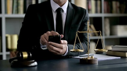Successful Businessman prosecutor judge tapping or scrolling on mobile phone smartphone and browsing internet online - Powered by Adobe