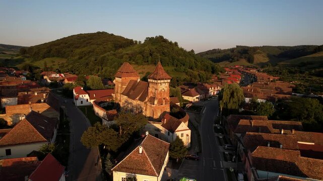 Drone over Valea Viilor Fortified Church in Romania at sunset. Aerial
