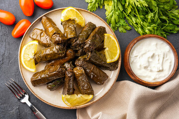 Delicious Turkish dish, stuffed vine leaves, on a black stone table