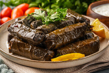 Delicious Turkish dish, stuffed vine leaves, on a black stone table