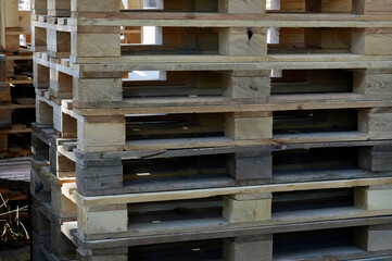 Wooden pallets stacked in a warehouse, ready for shipment.