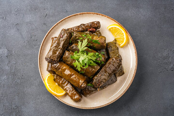 Delicious Turkish dish, stuffed vine leaves, on a black stone table