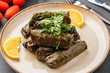 Delicious Turkish dish, stuffed vine leaves, on a black stone table