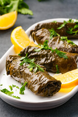 Delicious Turkish dish, stuffed vine leaves, on a black stone table