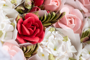 Home-made zephyr floristry arrangement featuring vibrant red and soft pink flowers, showcasing intricate details and textures, perfect for decorative purposes and celebrations