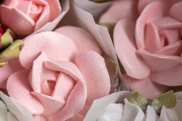 Home-made zephyr floristry featuring delicate pink and white rose-shaped confections arranged...