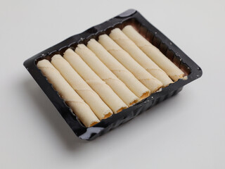 Rolled wafer or biscuits on white background