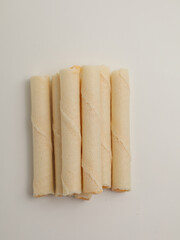 Rolled wafer or biscuits on white background
