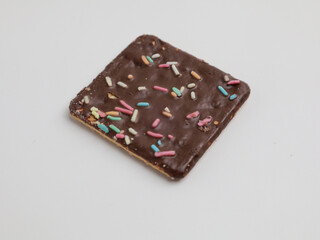 Crunchy crackers coated with chocolate and sprinkles