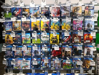 Obraz premium A wall of physical game discs for PlayStation consoles, featuring titles like Grand Theft Auto, Red Dead Redemption, and Spider-Man. Irpin, Ukraine, August 30, 2025.
