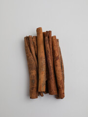 Cinnamon sticks piled on white background