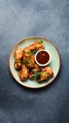 Buffalo chicken wings with sweet chili sauce. Close up. Top view.