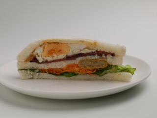 Egg and cheese sandwich on white background